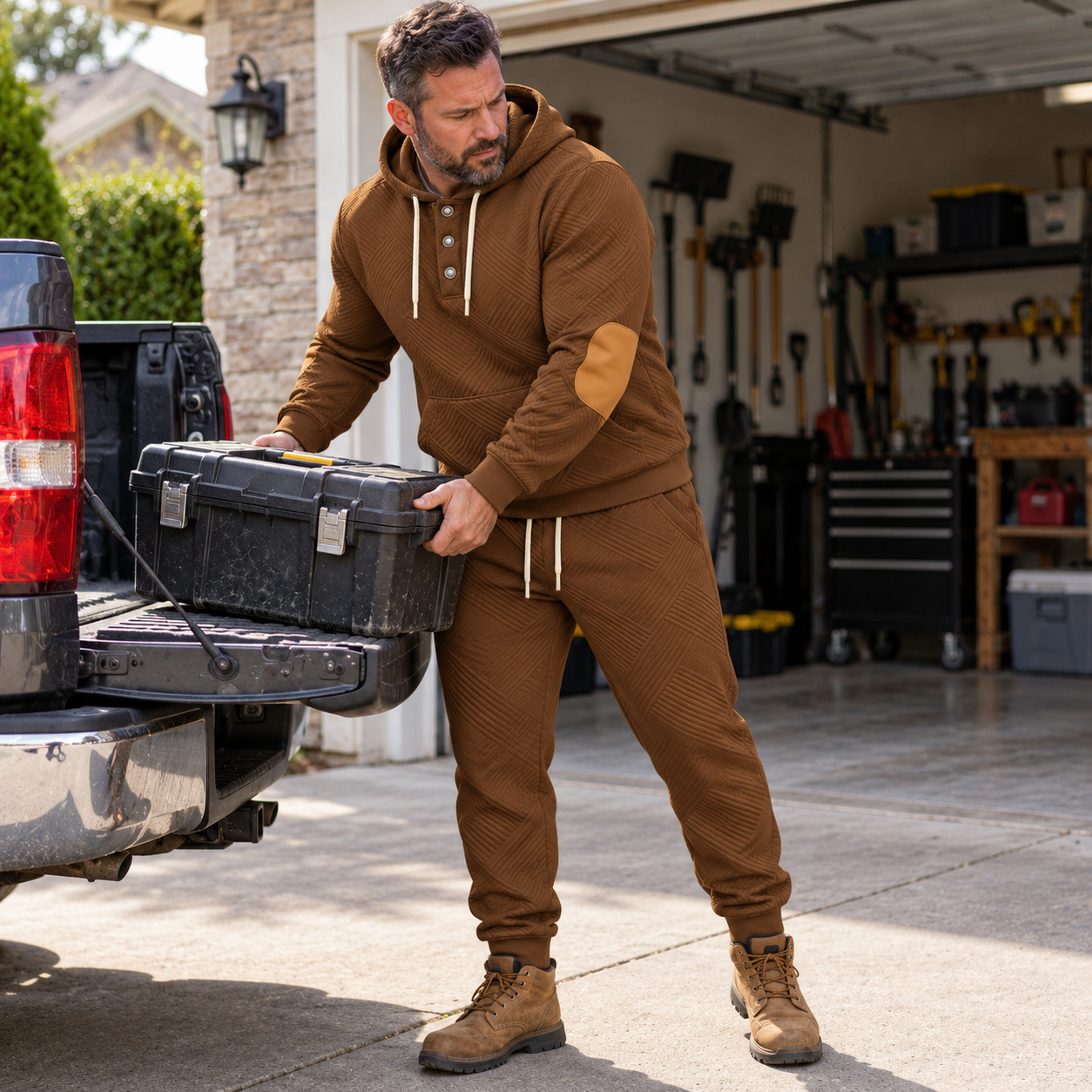 Man wearing caramel textured hoodie jogger set while unloading a toolbox