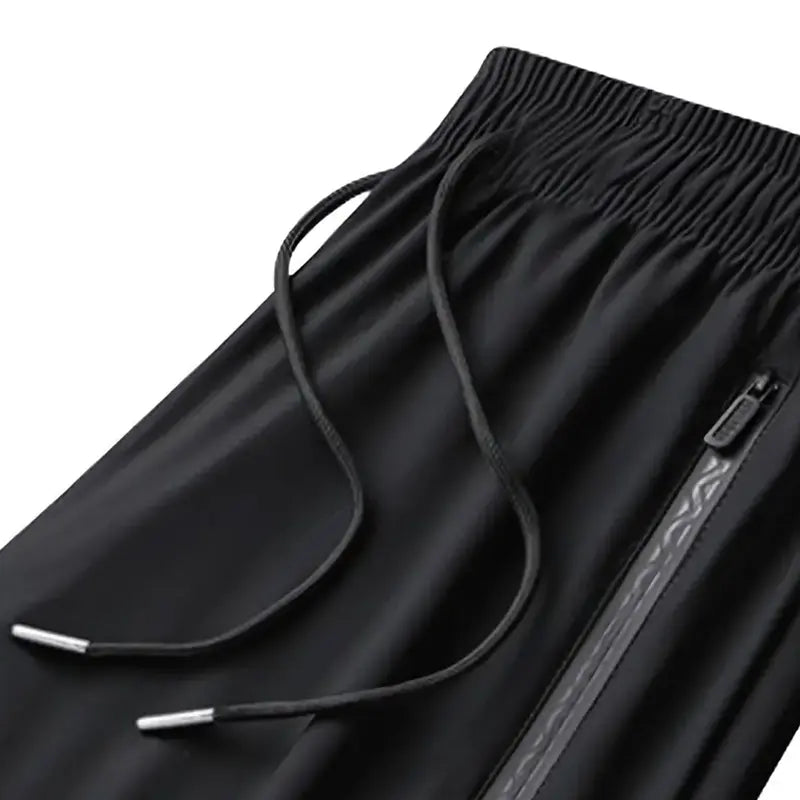 Elastic waistband, drawstring and zipper pocket detail